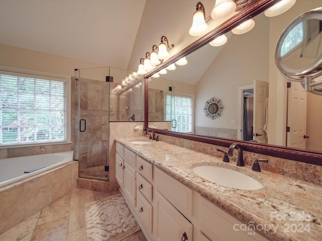 bathroom with separate shower and tub, tile patterned flooring, lofted ceiling, and double sink vanity