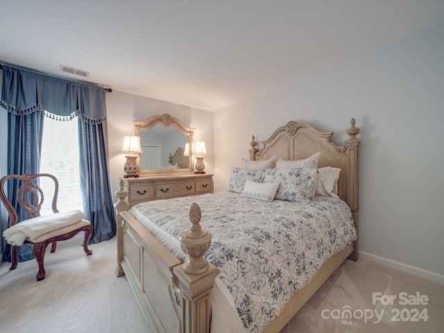 bedroom with light colored carpet