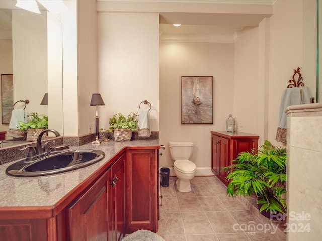 bathroom with vanity, crown molding, tile patterned flooring, and toilet