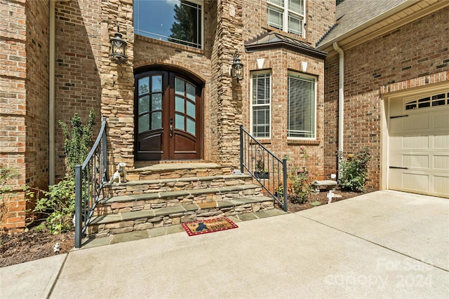 doorway to property featuring a garage