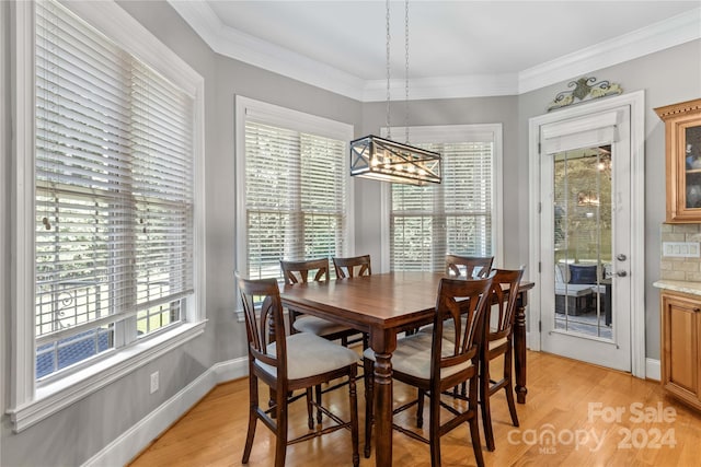 dining space with plenty of natural light, light hardwood / wood-style flooring, and ornamental molding