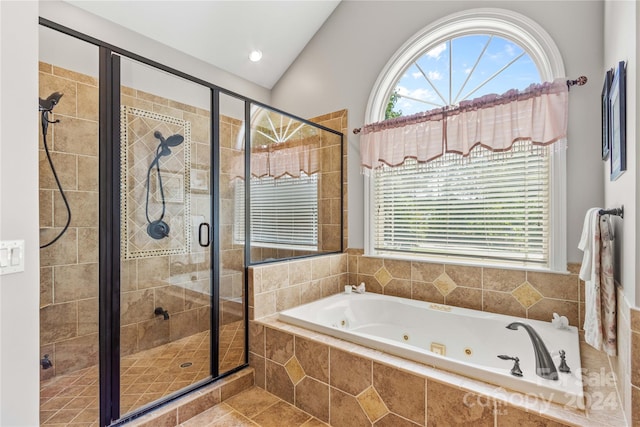 bathroom featuring tile patterned flooring, lofted ceiling, and shower with separate bathtub