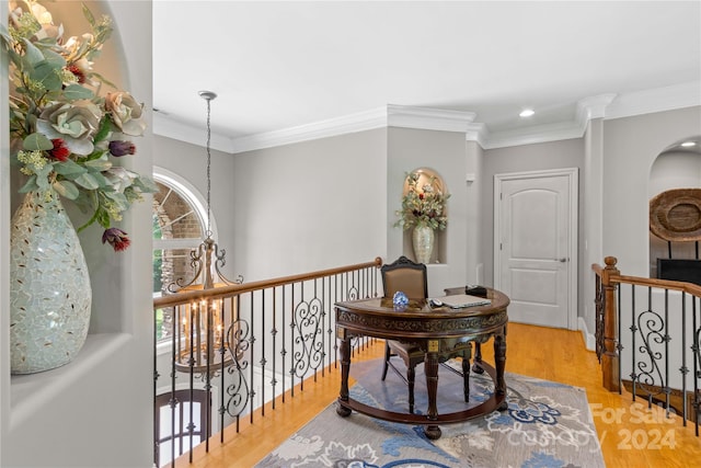 hallway with ornamental molding and light hardwood / wood-style flooring