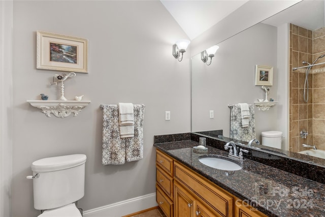 full bathroom featuring toilet, vanity, and tiled shower / bath