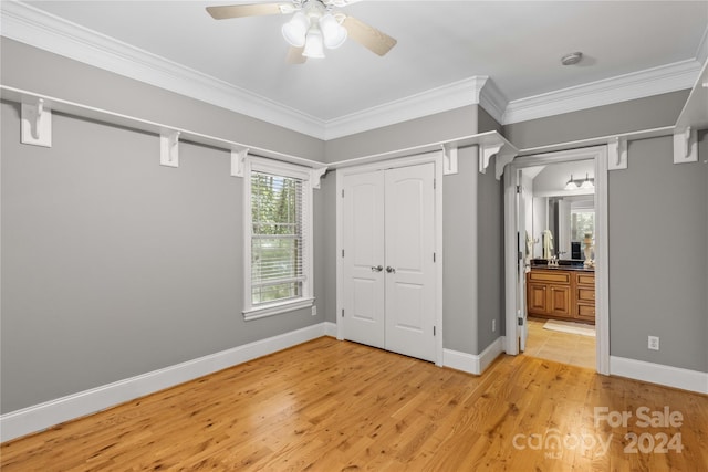 unfurnished bedroom with a closet, light hardwood / wood-style flooring, ornamental molding, and ceiling fan