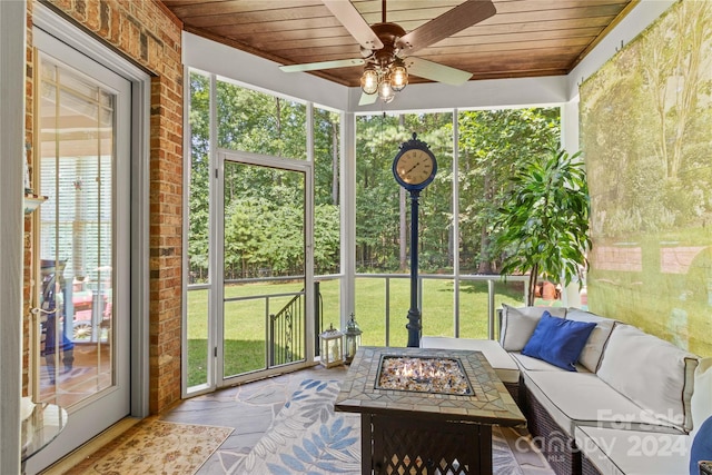 sunroom / solarium with ceiling fan and wooden ceiling