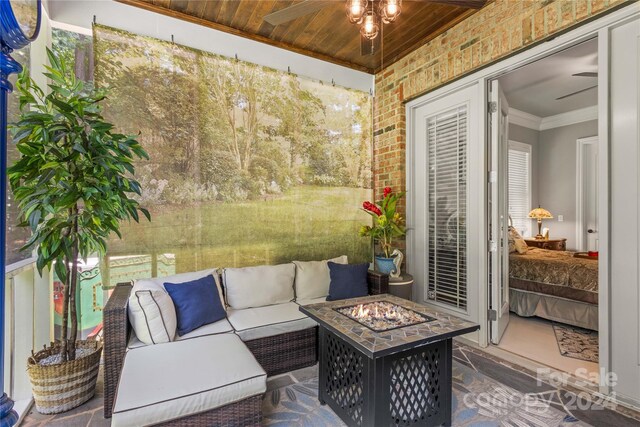 view of patio featuring an outdoor living space with a fire pit and ceiling fan