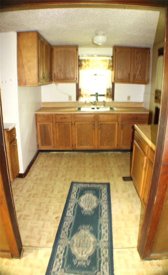 kitchen featuring sink and a textured ceiling