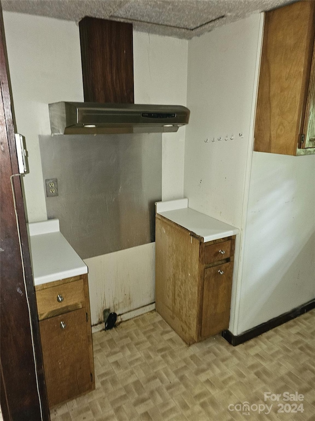 kitchen featuring wall chimney exhaust hood