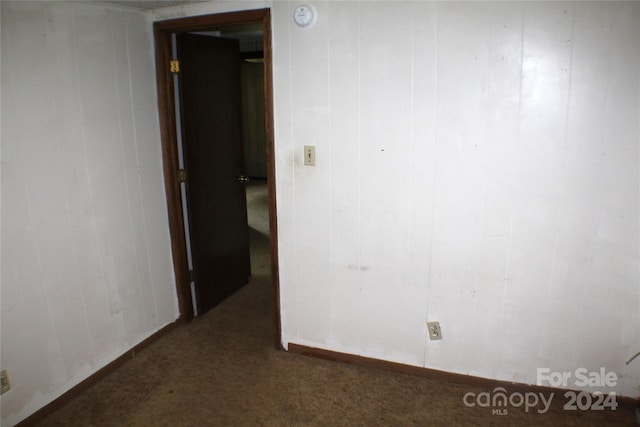 empty room featuring dark colored carpet