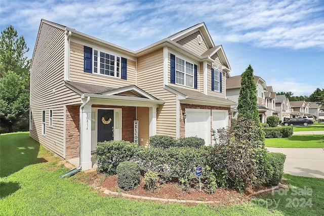 view of front of house featuring a garage, driveway, brick siding, and a front lawn