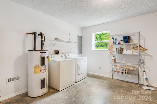 clothes washing area with electric panel, electric water heater, washer and dryer, and a textured ceiling