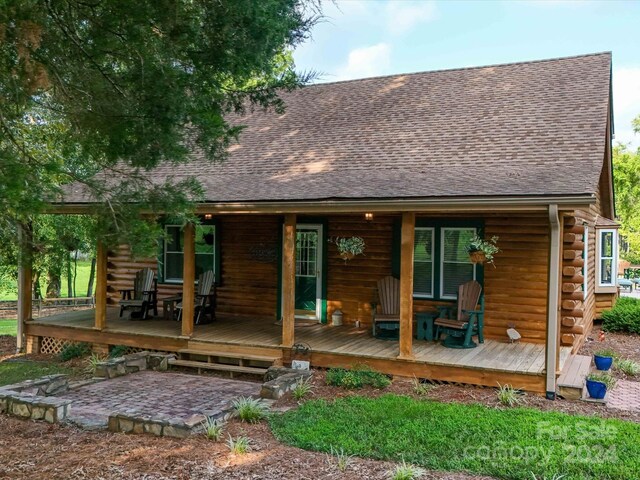 back of property featuring a deck