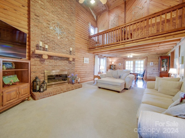 carpeted living room with a brick fireplace and a towering ceiling