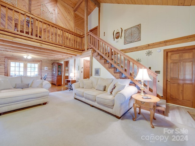 living room with wooden ceiling and high vaulted ceiling