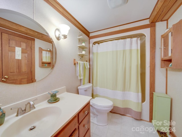 bathroom with tile patterned flooring, ornamental molding, vanity, and toilet