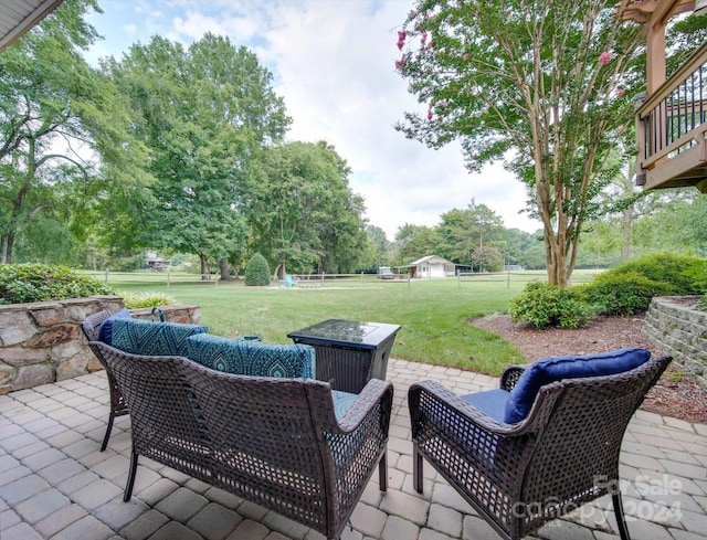 view of patio / terrace with an outdoor living space with a fire pit