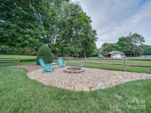 view of yard featuring an outdoor fire pit