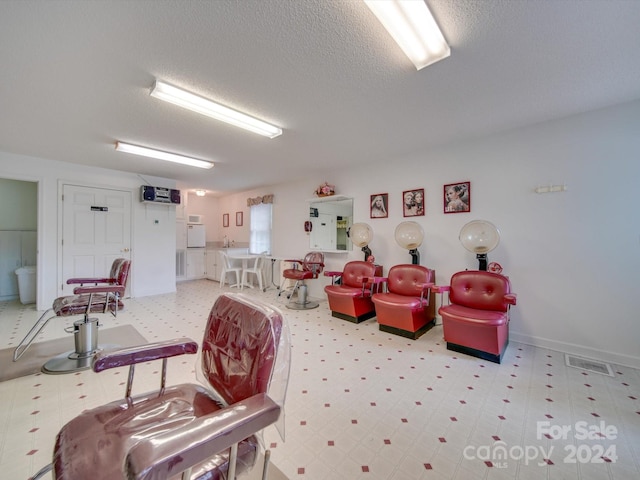 recreation room featuring a textured ceiling