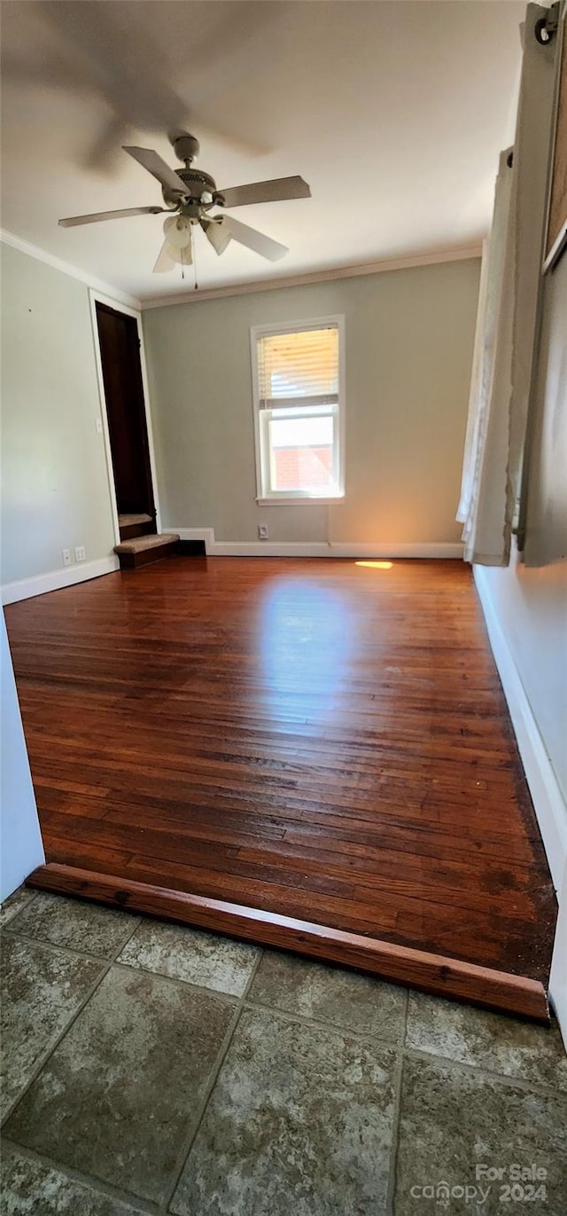 spare room with hardwood / wood-style floors, ceiling fan, and ornamental molding