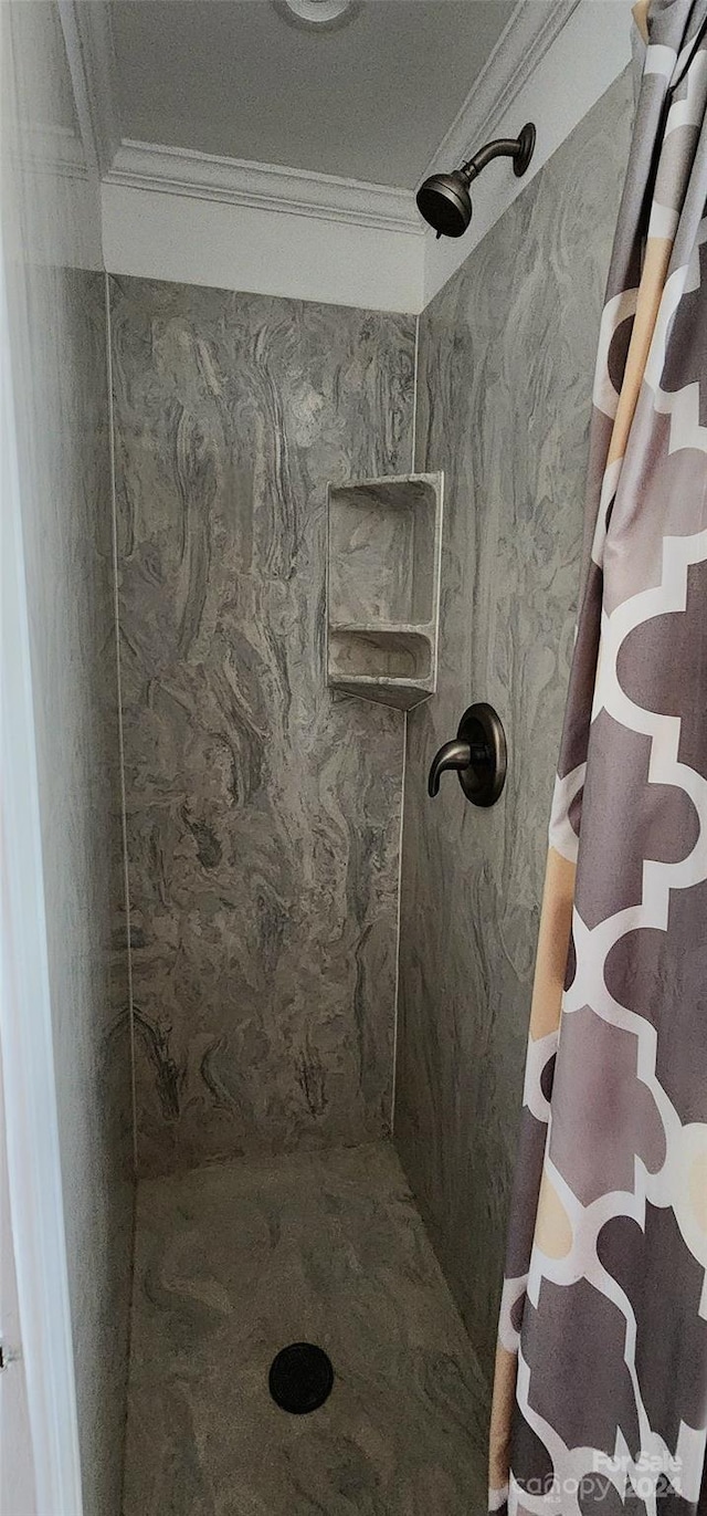 bathroom with crown molding and a shower with shower curtain