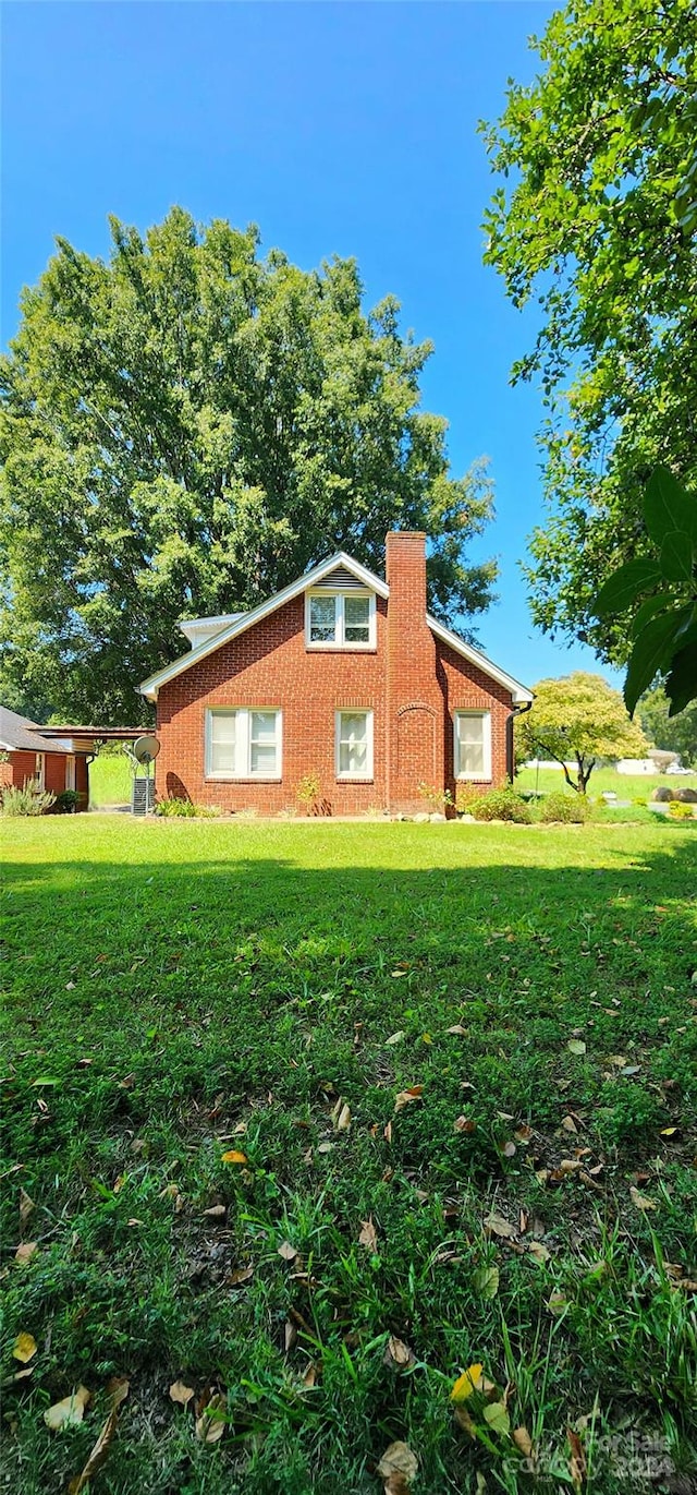 view of home's exterior with a yard