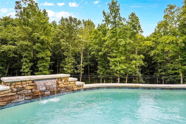 view of pool featuring pool water feature