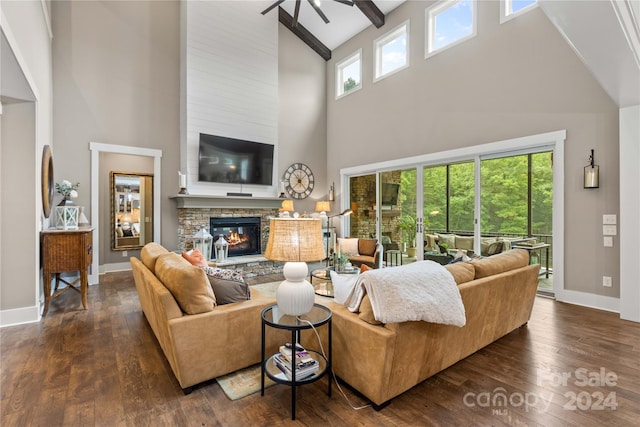 living room with a stone fireplace, dark wood-type flooring, beamed ceiling, and high vaulted ceiling