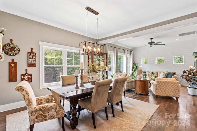 dining space featuring ceiling fan with notable chandelier and dark hardwood / wood-style flooring