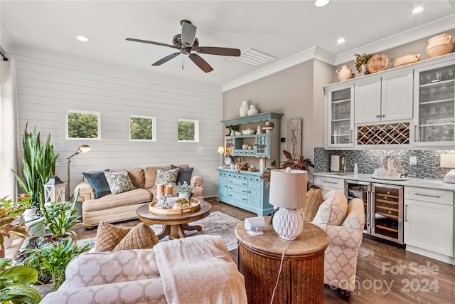 living room featuring wood walls, dark wood-type flooring, ceiling fan, and beverage cooler