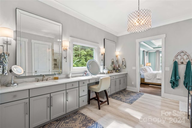 bathroom featuring double vanity, hardwood / wood-style flooring, and crown molding