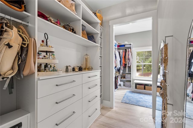 walk in closet featuring light hardwood / wood-style flooring