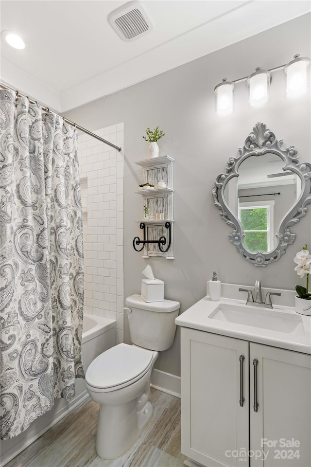 full bathroom with hardwood / wood-style floors, shower / bath combo, toilet, and vanity