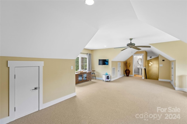 additional living space with light carpet, ceiling fan, and vaulted ceiling