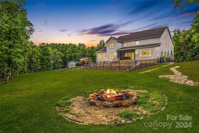 yard at dusk with an outdoor fire pit