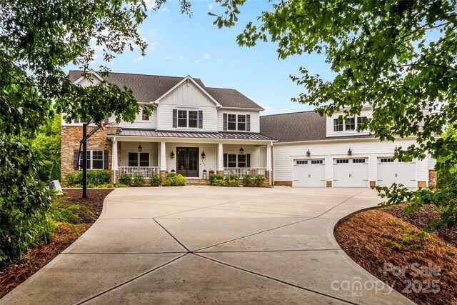 127 Tradition Ln, Mooresville, NC 28115 - view of front facade with a standing seam roof, board and batten siding, metal roof, a porch, and driveway