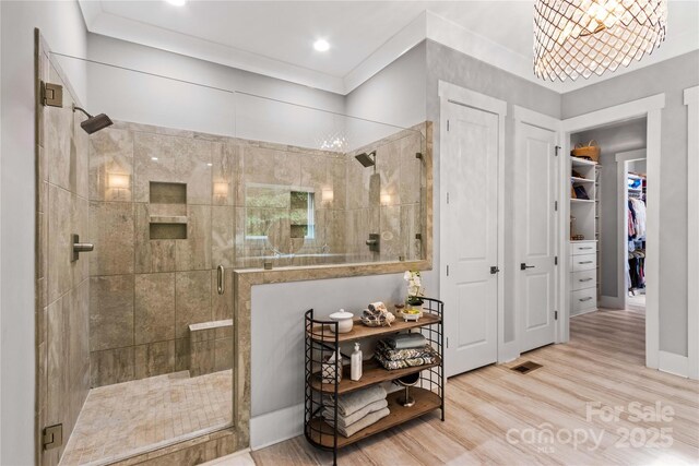 127 Tradition Ln, Mooresville, NC 28115 - bathroom with visible vents, wood finished floors, recessed lighting, a spacious closet, and a stall shower