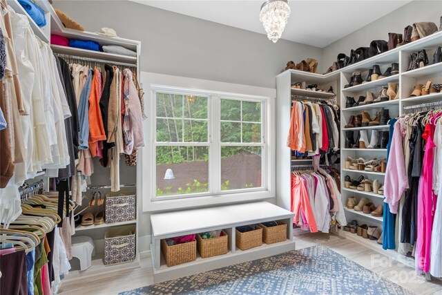 127 Tradition Ln, Mooresville, NC 28115 - walk in closet with wood finished floors and a notable chandelier