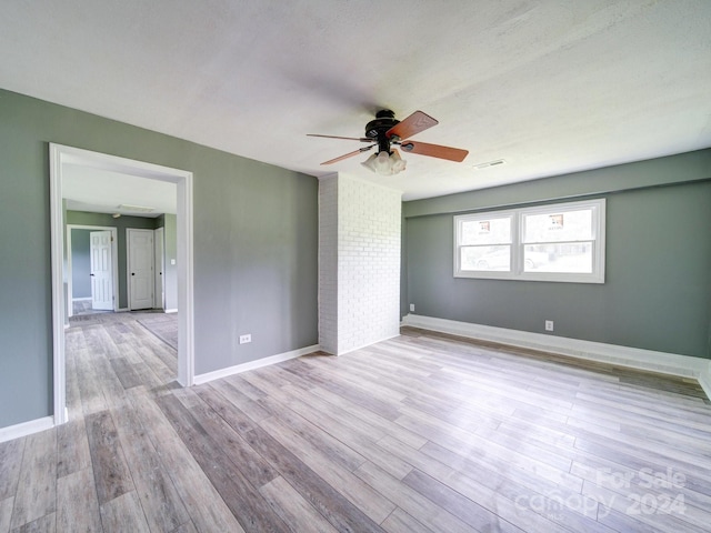 spare room featuring ceiling fan and light wood-type flooring