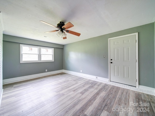 empty room featuring ceiling fan and light hardwood / wood-style flooring