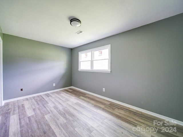 spare room with light hardwood / wood-style flooring