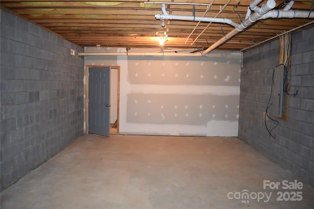 unfinished basement featuring electric panel