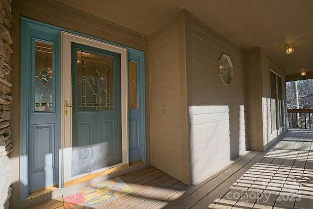 view of exterior entry with a porch