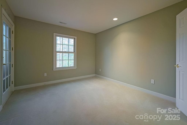 spare room featuring recessed lighting, visible vents, baseboards, and light colored carpet