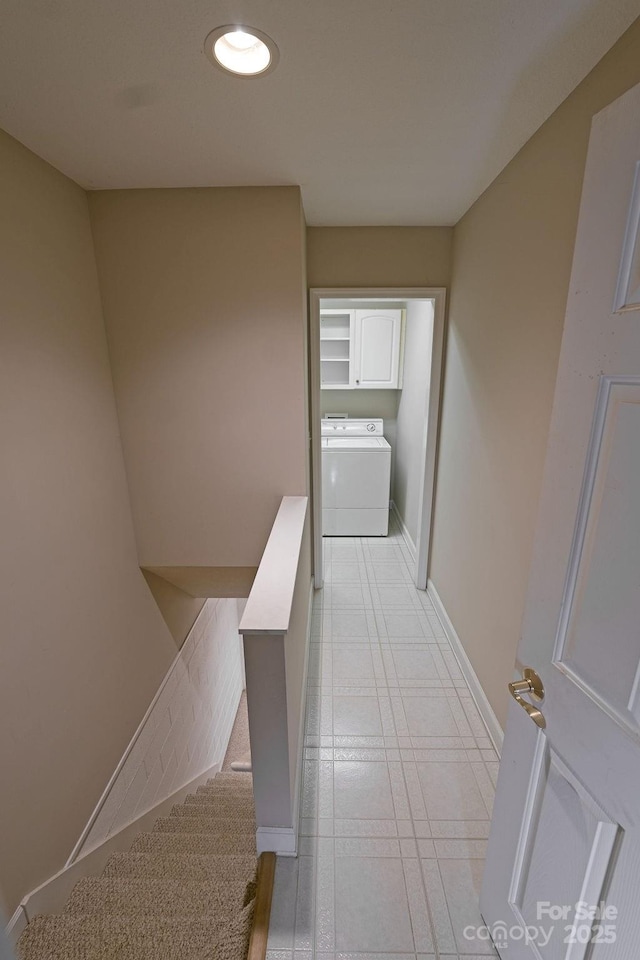 hall featuring light tile patterned floors, recessed lighting, an upstairs landing, washer / dryer, and baseboards