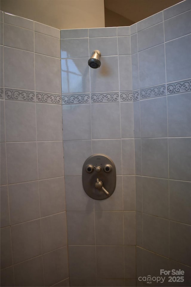 bathroom with tiled shower