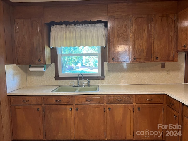 kitchen featuring backsplash and sink