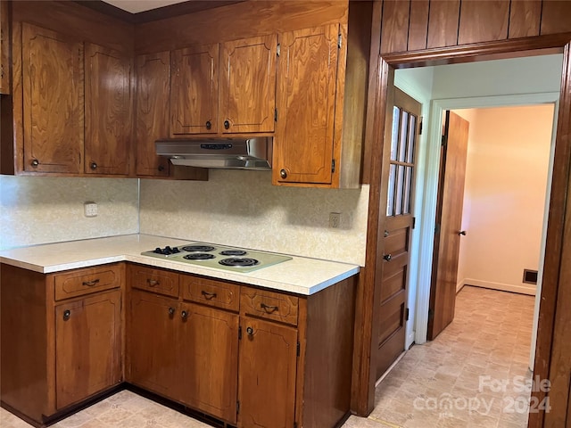 kitchen with decorative backsplash and white electric stovetop