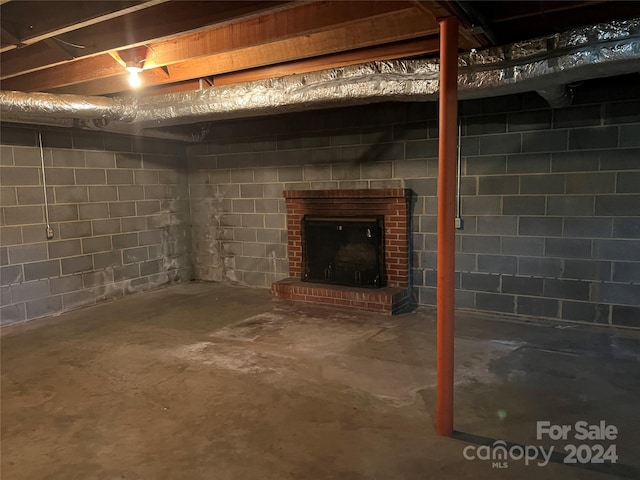 basement featuring a brick fireplace