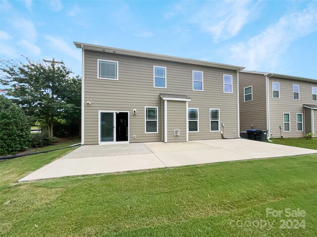 rear view of property with a yard and a patio area